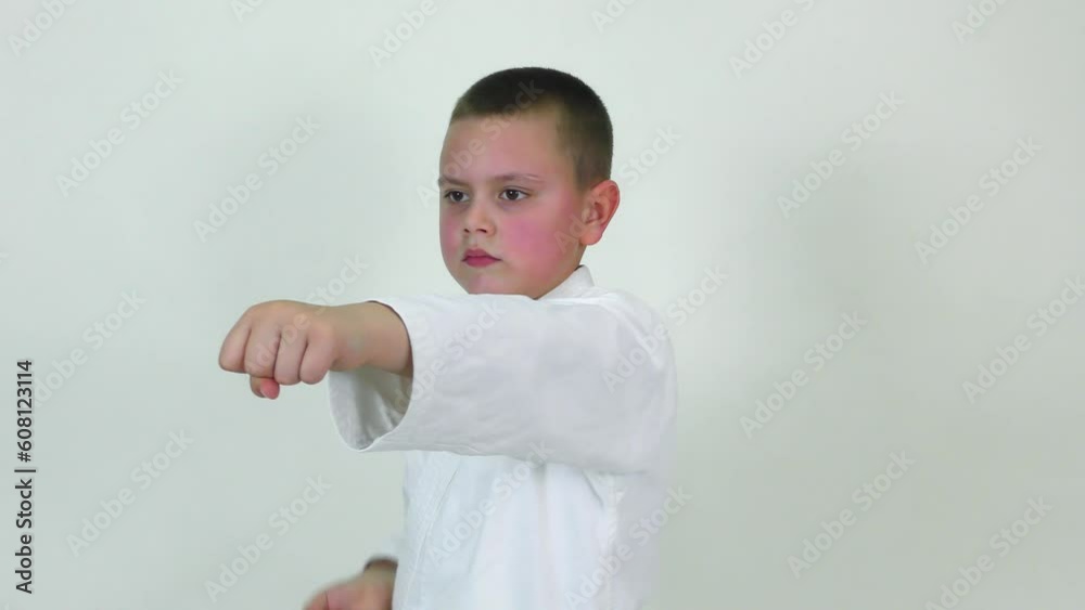 On a white background, an athlete with a yellow belt beats straight punches On a white background, an athlete with a yellow belt beats straight punches