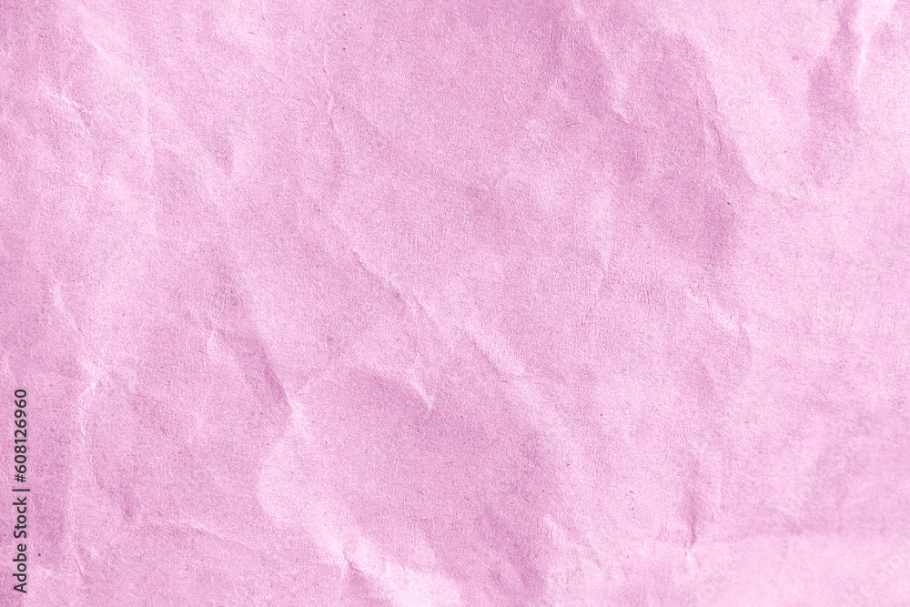 Wrinkled pink paper as a background or wallpaper