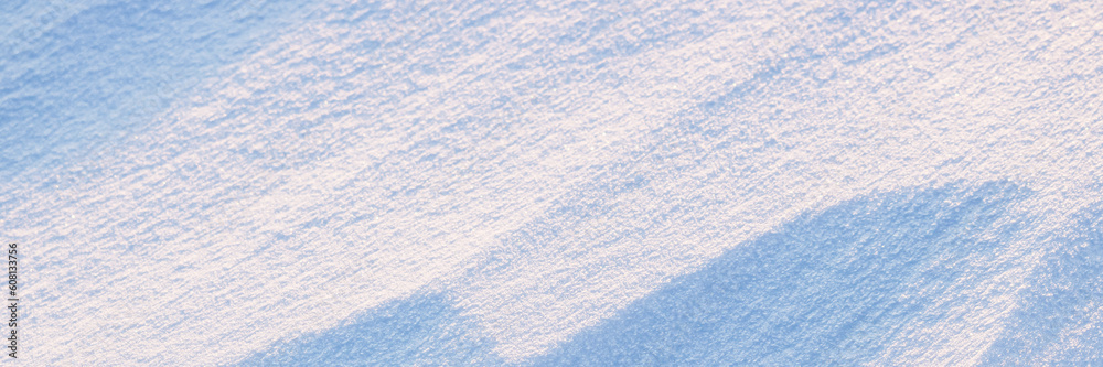 Snow texture. Wind sculpted patterns on snow surface. Wind in the tundra and in the mountains on the surface of the snow sculpts patterns and ridges. Arctic, Polar region. Winter panoramic background. Snow texture. Wind sculpted patterns on snow surface. Wind in the tundra and in the mountains on the surface of the snow sculpts patterns and ridges. Arctic, Polar region. Winter panoramic background.