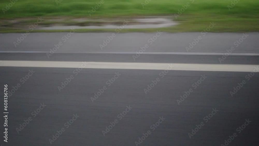 The side of a road seen from a moving bus The side of a road seen from a moving bus