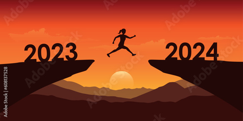 woman jumping over a cliff from 2023 to 2024 at dramatic sunset