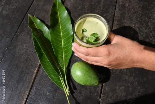 Raw Mango Drink. This is a traditional and most popular drink of Indian in summer. It's other names Kairi panha, Panna, Raw Mango juice. Drink beverage served in a glass. Selective focus. photo