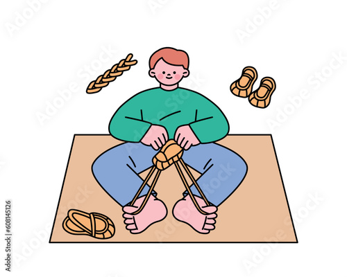 Hobby class. A boy is making traditional Korean straw shoes.