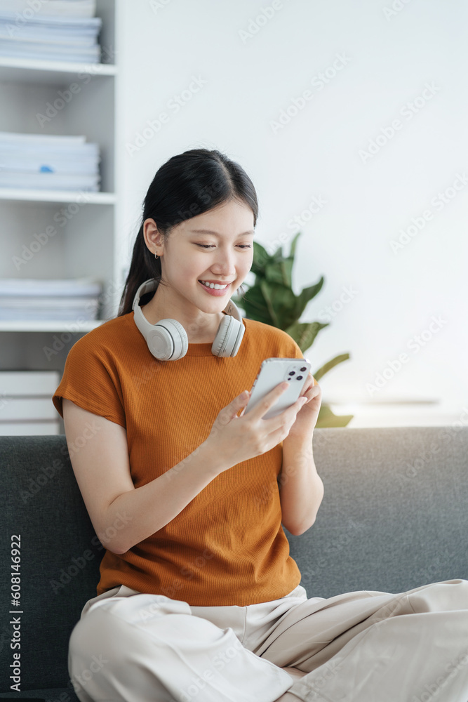 Asian women using mobile phone play Social media in home office. Asian women using mobile phone play Social media in home office.