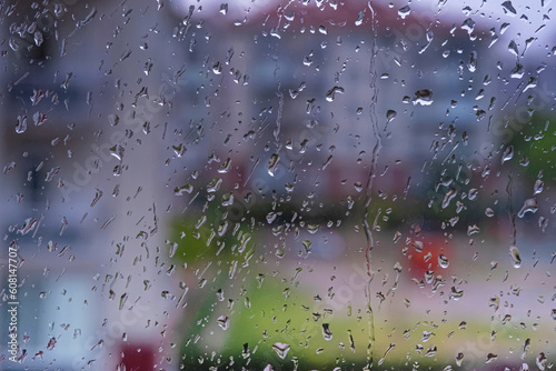 Rain drops on window. Raining in rainy day outside window glass with blurred background