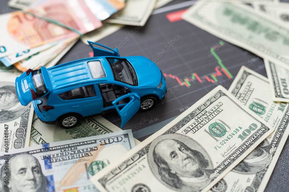 Fototapeta premium Coins stacking on the bank notes in front of the car