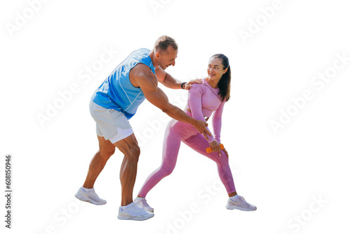 Handsome caucasian trainer explains how to do exercise to female client against transparent background. Brunette woman training with dumbbells, smiles satisfied by workout. Personal trainer