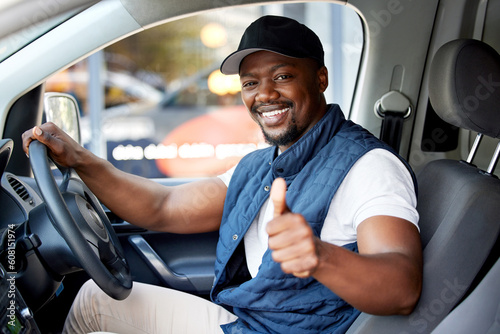 Delivery guy, transport or man driving with thumbs up, shipping or courier service. Happy black person, portrait or driver for like, support emoji or hand sign in van, cargo vehicle or transportation photo