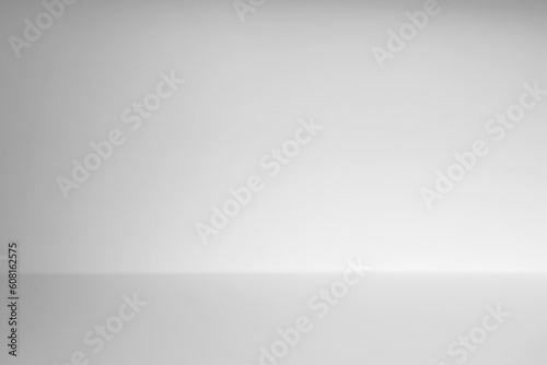 Abstract empty white and gray gradient soft light background of studio room for art work design.