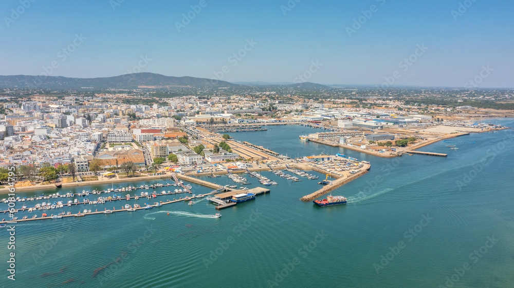Aerial view of Portuguese fishing tourist town of Olhao with a view the Ria Formosa Marine Park. Sea port for yachts moored at the berths