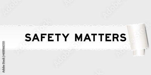 Ripped gray paper background that have word safety matters under torn part