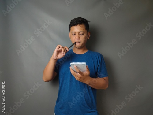 Young asian man shocked when he looking and pointing smartphone