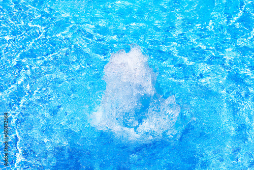Splashing in blue turquoise water . Fountain with blue transparent water