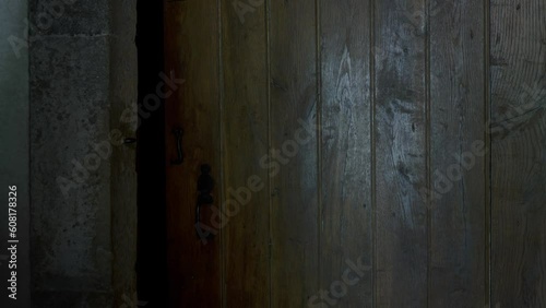 Antique wooden door opens into darkness. halloween concept