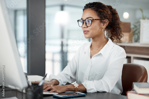 Professional woman at desk, working at computer with email and writing article at digital marketing agency. Focus, web design and typing at desktop PC with female copywriter, notes and SEO content