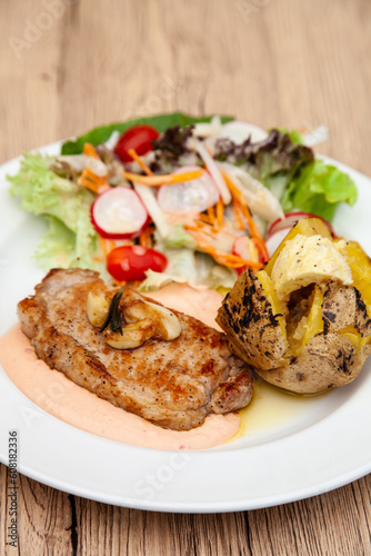 Pork sirloin steak with baked potato and andalouse sauce