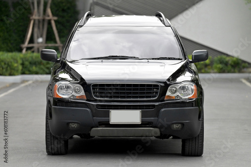 car  straight front view See the twin headlights and the hood of the car.