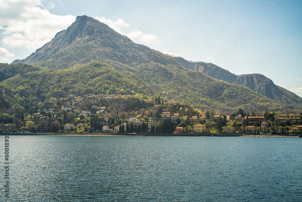 Lake Como from the shore of the city of Lecco. View of the Alps mountains, buildings and the town of Malgrate.
