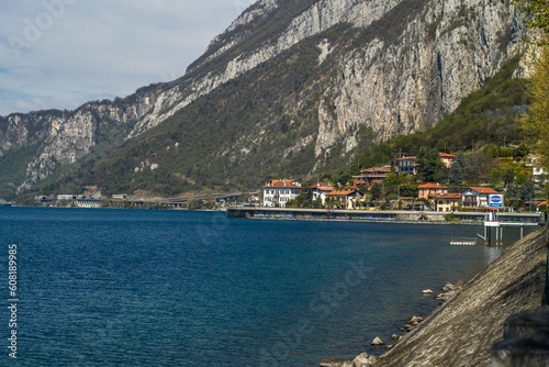 Lake Como from the shore of the city of Lecco. View of the Alps mountains, buildings and the town of Malgrate. 