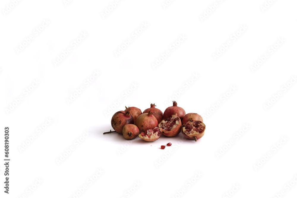 Obraz premium Pomegranate apples and seeds or grains isolated on white background. Minimalist concept.