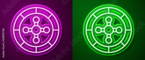 Glowing neon line Casino roulette wheel icon isolated on purple and green background. Vector