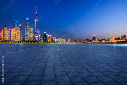 Empty square floor and city skyline with building at night in Shanghai