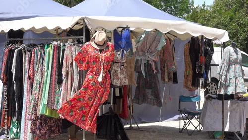 Sale of fashionable clothes in a tent at the clothing market on the street