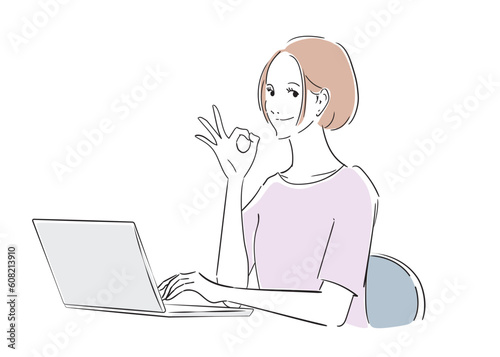 ノートパソコンで仕事しながらオーケーしている女性