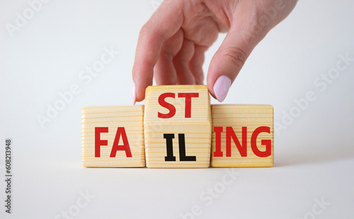 Fasting vs Failing symbol. Businessman hand turns wooden cubes and changes the word Failing to Fasting. Beautiful white background. Fasting vs Failing and business concept. Copy space