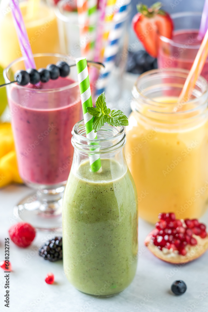 Fresh fruit smoothies with colourful straws surrounded by fresh fruit. Fresh fruit smoothies with colourful straws surrounded by fresh fruit.