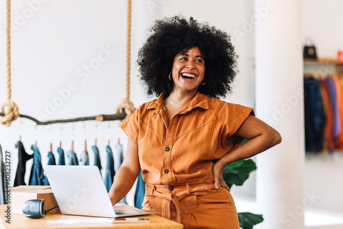 Ethnic small business owner smiling cheerfully in her shop photo