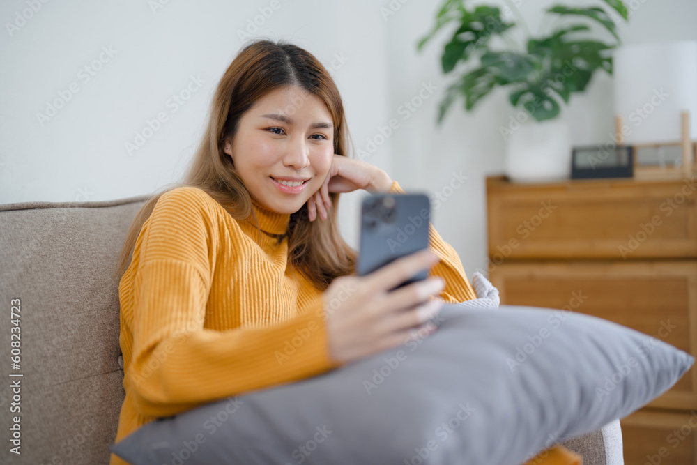 Happy asian woman using mobile phone for video conference at home. Happy asian woman using mobile phone for video conference at home.
