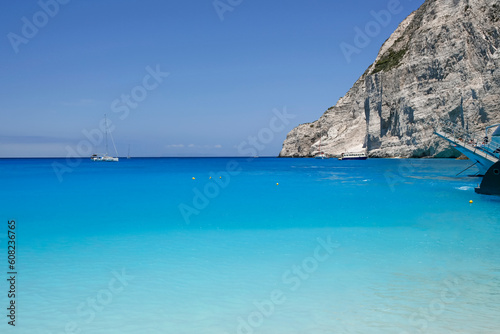turquoise water seen from the Navagio beach with high cliffs  touristic famous landmark on Zakynthos island  Greece