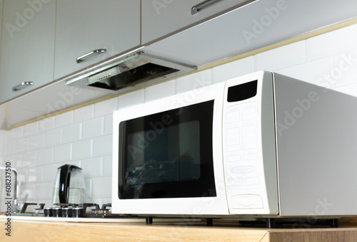 Modern microwave oven in the kitchen. Interior of kitchen with modern microwave oven. Cooking food. Space for text.Space for copy. Close-up.