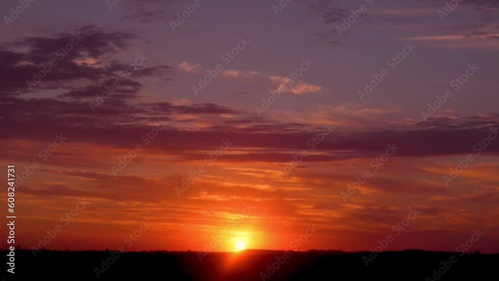 Dramatic Fiery Blue Purple Yellow Sky Sun Setting Horizon and Clouds at Sunset in Field Timelapse. Amazing Colorful Summer Sunset Sky, Sun, Clouds, Evening Incredible Sky Sun Sets Colored Clouds. Dramatic Fiery Blue Purple Yellow Sky Sun Setting Horizon and Clouds at Sunset in Field Timelapse. Amazing Colorful Summer Sunset Sky, Sun, Clouds, Evening Incredible Sky Sun Sets Colored Clouds.