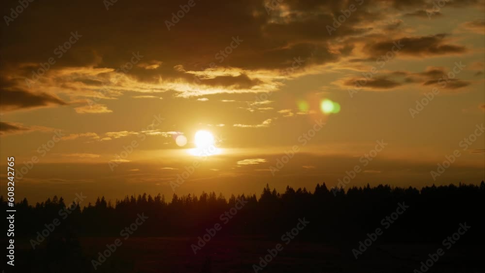 Timelapse. Sunset. The yellow sun slowly moves across the sky hiding behind the clouds Timelapse. Sunset. The yellow sun slowly moves across the sky hiding behind the clouds