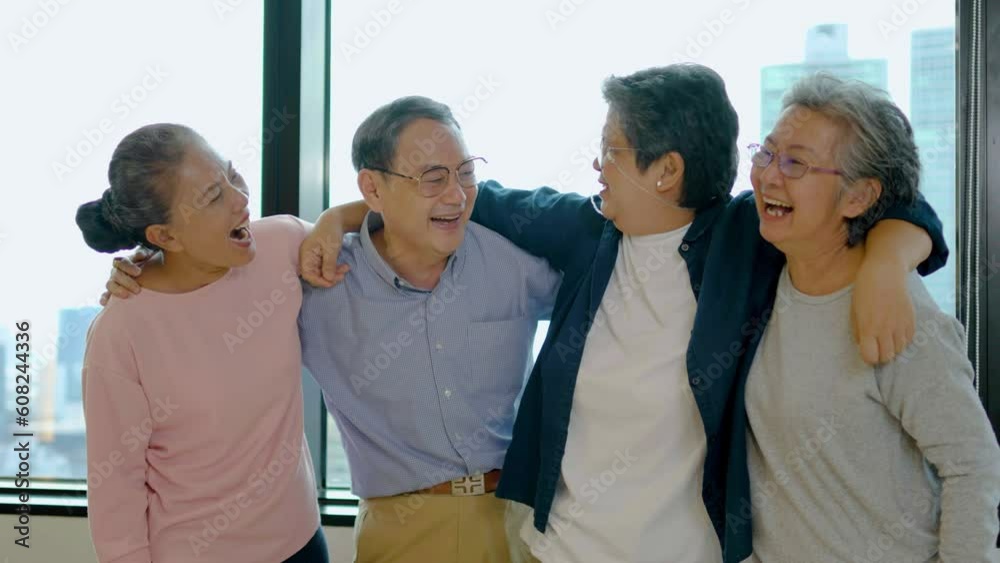 Group of happy asian senior friends chatting and laughing together with hugging each other indoor, Older friends community concept, slow motion Group of happy asian senior friends chatting and laughing together with hugging each other indoor, Older friends community concept, slow motion