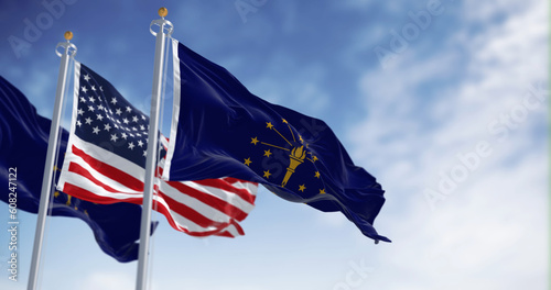 Indiana state flag waving with the national flag of the US on a clear day photo