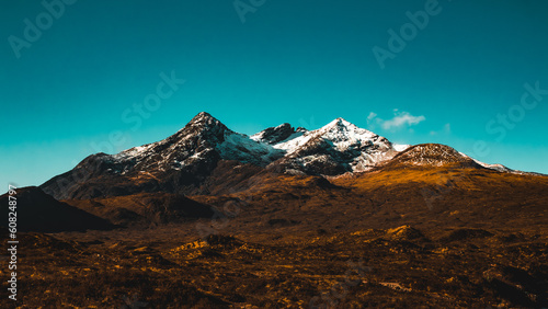 Wide shot of a snow capped mountain range on the Isle of Skye, Scotland