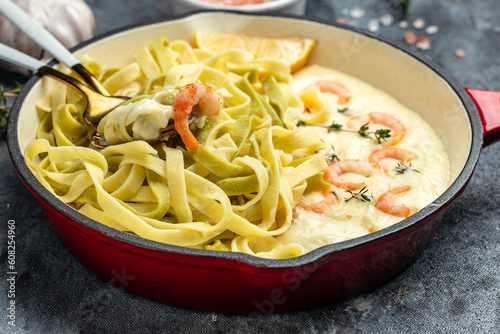 Pasta with Shrimp and bechamel sauce in a pan. Food recipe background. Close up