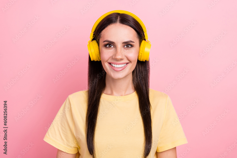 Photo of cheerful good mood woman dressed yellow t-shirt enjoying music headphones isolated pink color background Photo of cheerful good mood woman dressed yellow t-shirt enjoying music headphones isolated pink color background