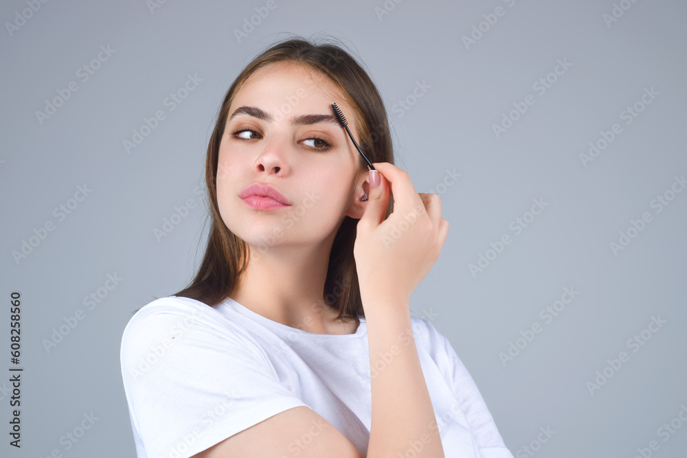 Beautiful woman with perfect shape eyebrows. Womans brows close up. Beautiful girl with eyebrow brush. Eyebrow correction. Long eyelashes and thick eyebrows. Beautiful woman with perfect shape eyebrows. Womans brows close up. Beautiful girl with eyebrow brush. Eyebrow correction. Long eyelashes and thick eyebrows.