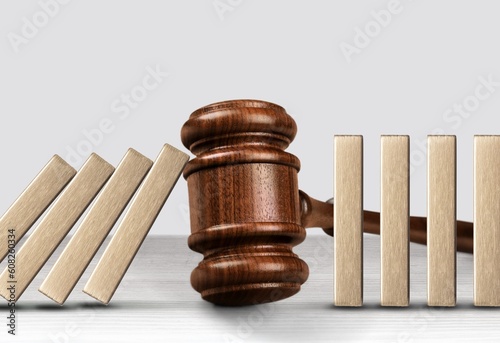 Фотография Judge wooden gavel. Stop domino effect concept