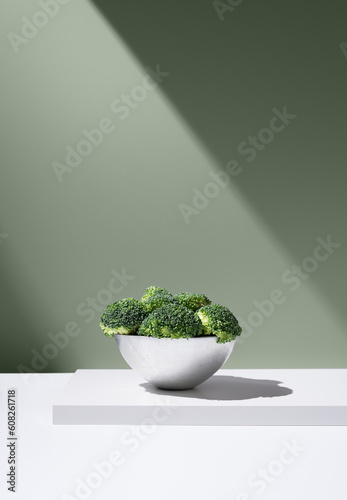Green broccoli in white bowl over table