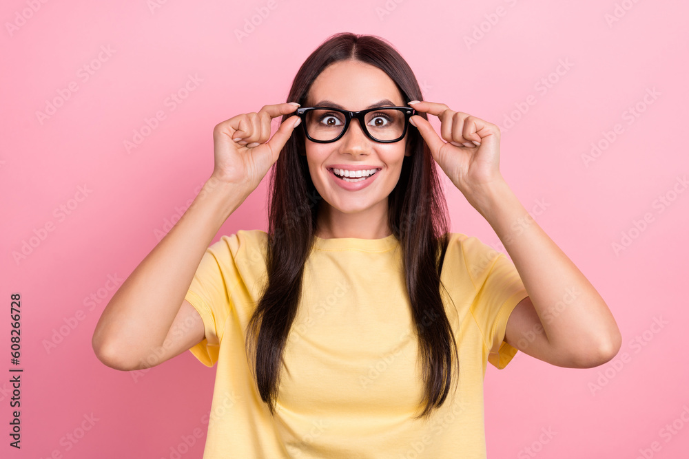 Photo of adorable excited lady wear yellow t-shirt arms spectacles big eyes isolated pink color background Photo of adorable excited lady wear yellow t-shirt arms spectacles big eyes isolated pink color background