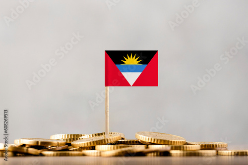 The Flag of Antigua and Barbuda with Coins. photo