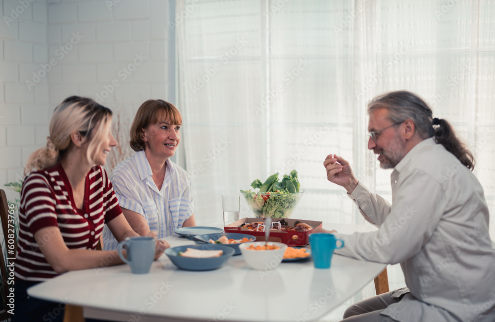 Members of the family from multiple generations enjoy quality time together by eating, snacking, chatting, discussing, learning about each other's interests, and strengthening stronger relationships. Members of the family from multiple generations enjoy quality time together by eating, snacking, chatting, discussing, learning about each other's interests, and strengthening stronger relationships.
