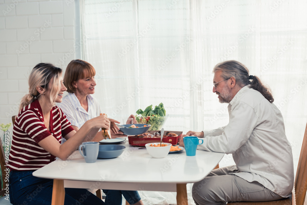 Members of the family from multiple generations enjoy quality time together by eating, snacking, chatting, discussing, learning about each other's interests, and strengthening stronger relationships. Members of the family from multiple generations enjoy quality time together by eating, snacking, chatting, discussing, learning about each other's interests, and strengthening stronger relationships.