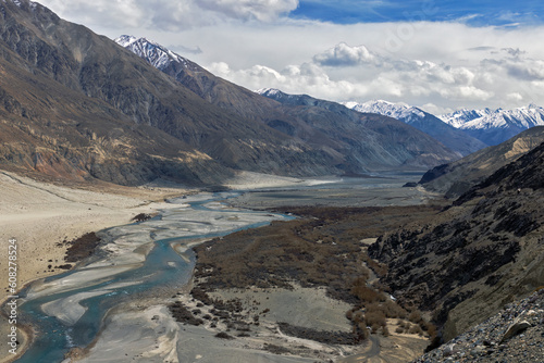 Captivating Suru Valley as it winds through the majestic mountains, while the shimmering Indus River flows under the sunny sky in Ladakh region, India