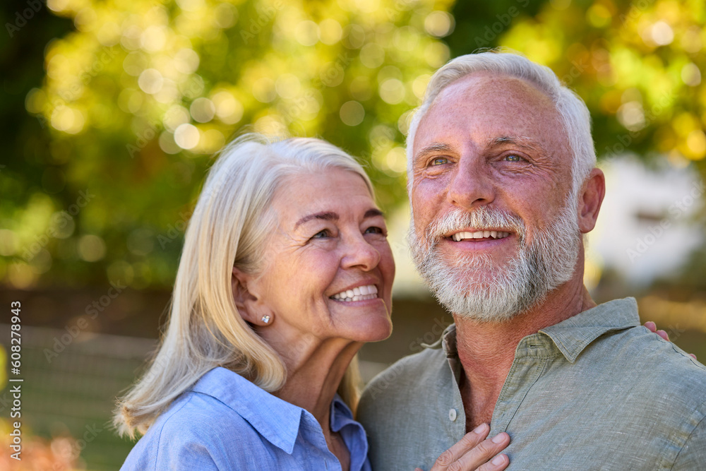 Portrait Of Loving Senior Couple Standing Outdoors In Garden Park Or Countryside